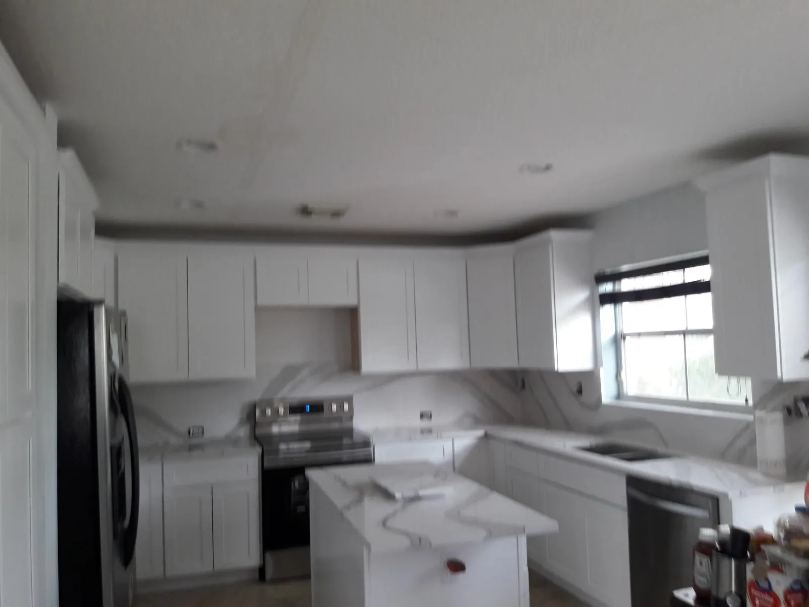 White kitchen remodel with wood flooring in Fort Lauderdale, FL
